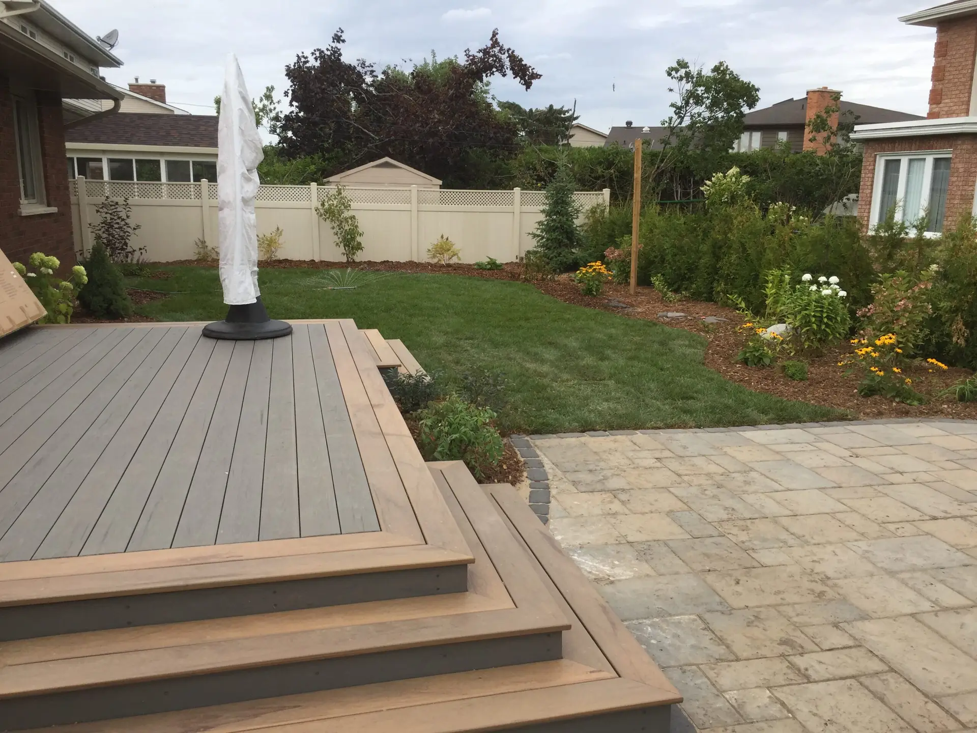 Ottawa Composite Deck in a Landscaped Backyard by Ottawa Deck Builder