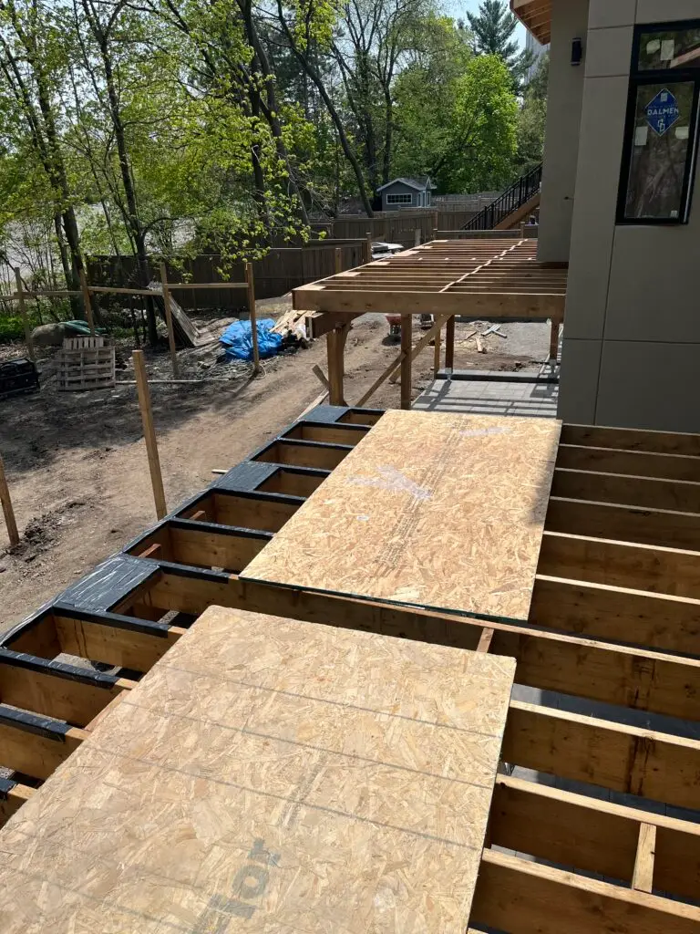 Installing deck joist tape to protect the framing for years to come