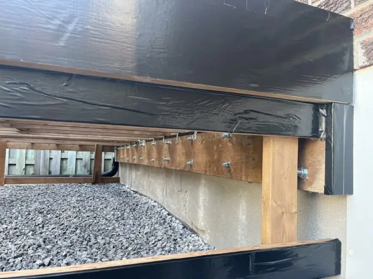 The ledger board of the deck is bolted to the house foundation