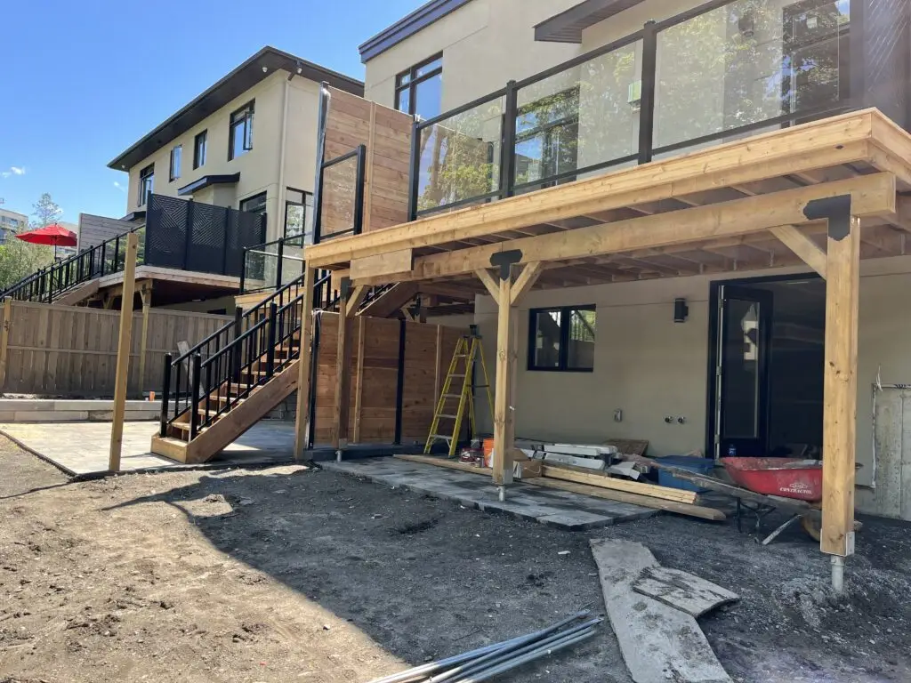A deck in Westboro with aluminum glass railing and a Hoft privacy screen