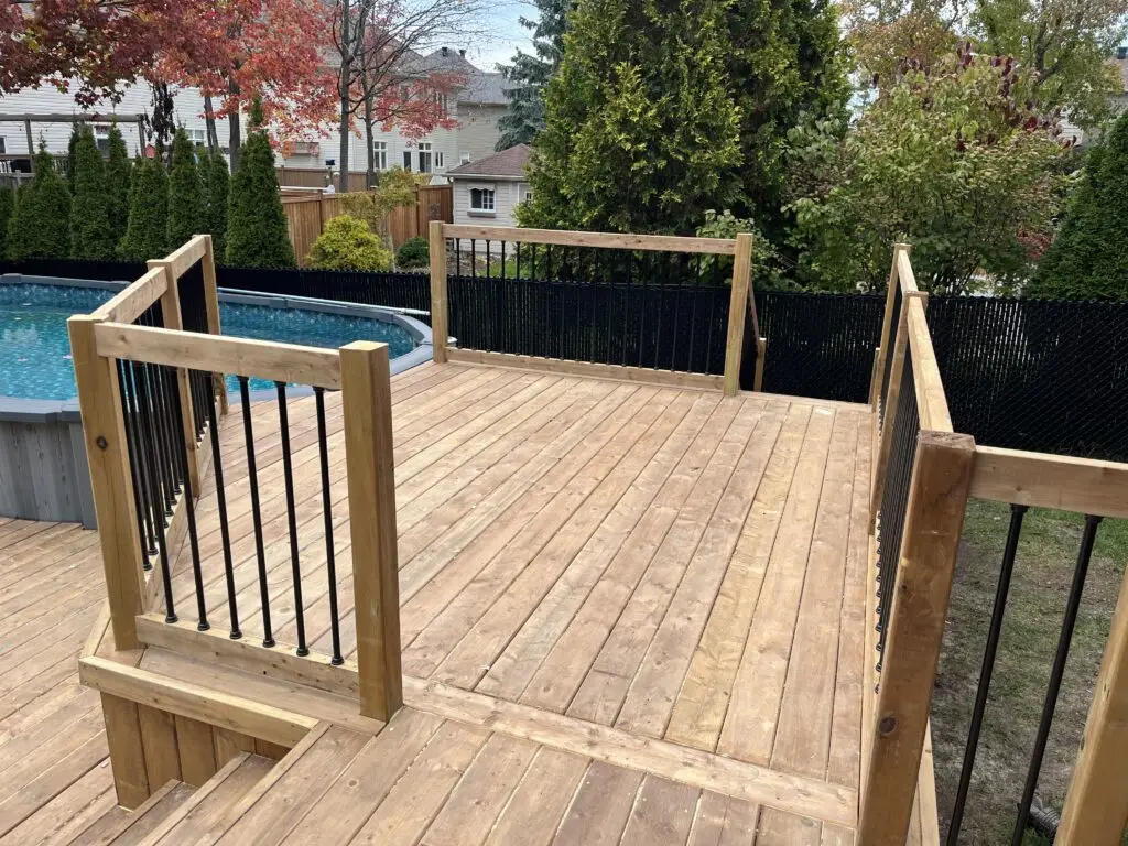 Pressure treated railing with black aluminum ballusters by Titan Building Products