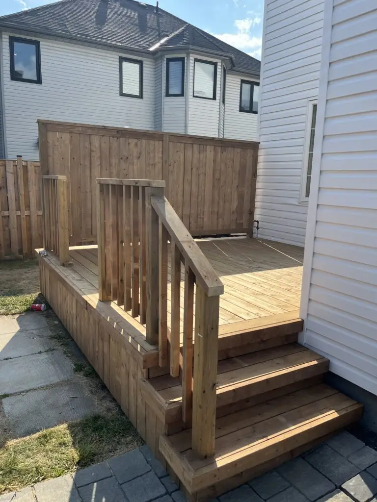 An Ottawa pressure treated deck with railing, privacy screen and vertical skirting