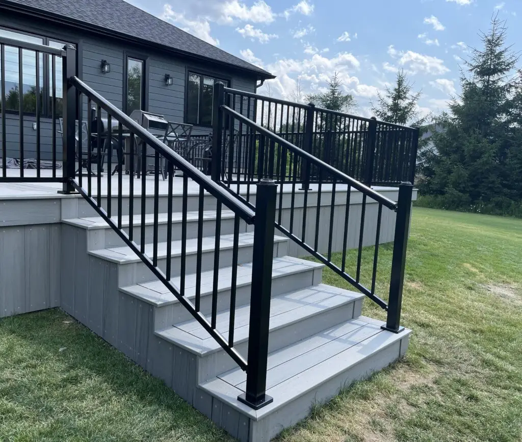A composite deck in Barrhaven with aluminum railing. Grand stairs extra wide